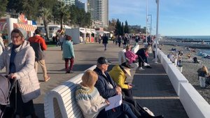 Дед Мороз в шубе и люди в майках на набережной в Сочи