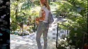 Kimberley Garner draws attention to her cleavage in plunging white bralet and tight plaid trousers