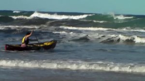 Surfing an open canoe on an ocean beach, NSW coast