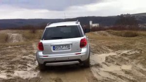 Suzuki SX4 4x4 offroading through mudhole