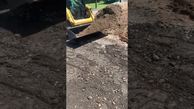 Cat skidsteer leveling topsoil in Old Forge PA