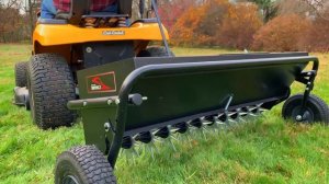 The Brinly Spike Aerator & Drop Spreader Combo Attachment