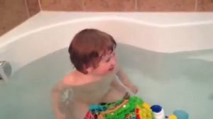 Brady blows bubbles in the bath