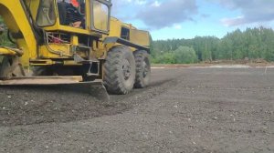 Укладка асфальтовой крошки на площадке Автогрейдером, Грейдером