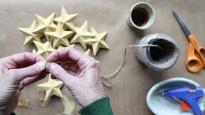 Adding twine to painted paper mache stars