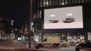 В центре Берлина на плазме у ТЦ ролик с текстом "Может не надо опять?"