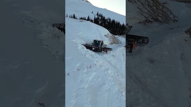 Mountain Top Snow Drift get Plowed by Snowcat