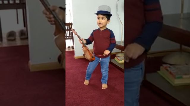 little malhar playing guitar