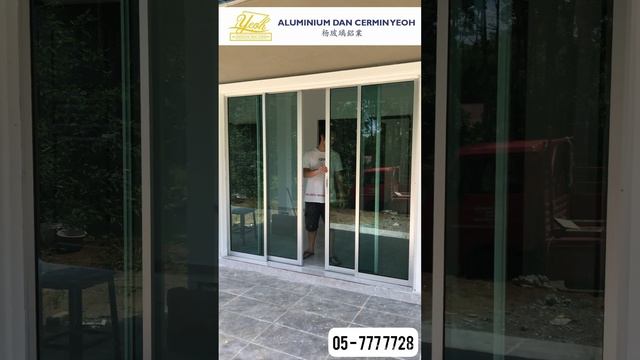 Aluminium economy sliding door with green tinted glass