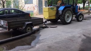 Выкачка воды с канализации трактором "Беларус"