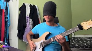 Beginner guitarists tries to play blindfolded.