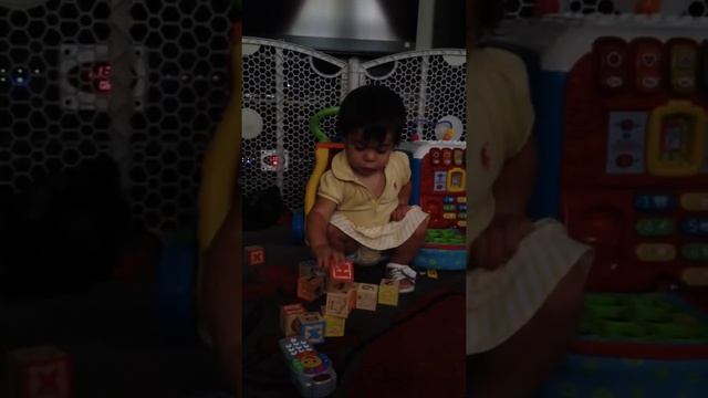 Allegra playing with blocks