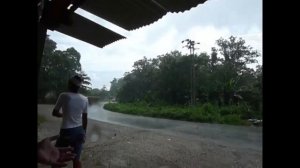 Brazilian children with a naked bottom in the rain