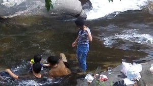 Wet jeans Girl at the waterfall