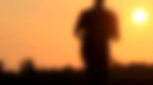 Силуэт бегущего мужчины на фоне заката. Футаж