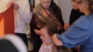 Covering the head and braiding two braids at the Russian wedding