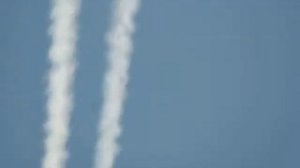 Blue and white airplane through telescope