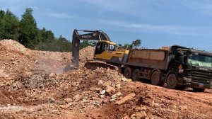 Excavator Volvo 300 loading dump truck scania