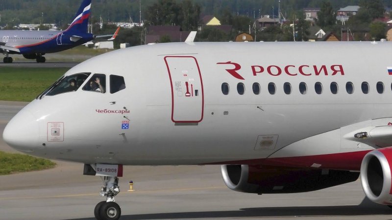 Both pilots of Rossiya Airlines greet the videographer, noticing that their airplane is being filmed