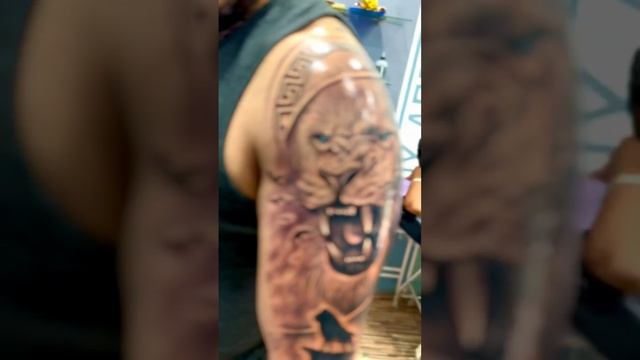 lion tattoo on biecep