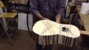 Pablo Requena fitting the bindings on a classical guitar