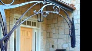 Красивый кованый навес над крыльцом частного дома