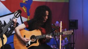Marty Friedman playing acoustic guitar.