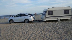 Lexus RX450 на пляже по песку с прицепом.