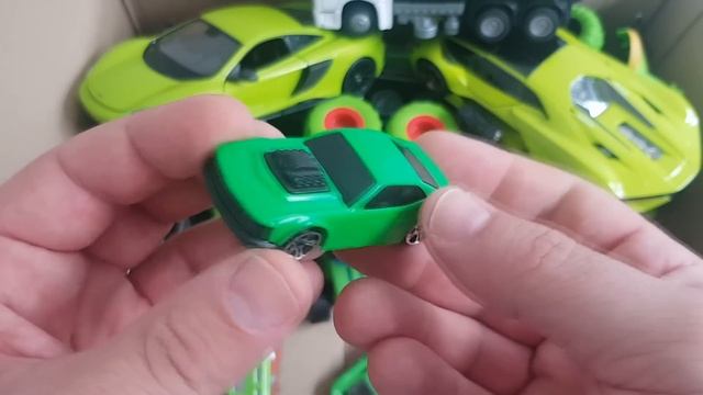 A box full of green car models