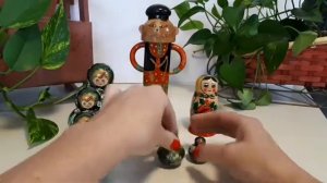 Деревянный мужичок и три вида красочных матрëшек. Wooden man and three kinds of nesting dolls.