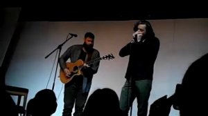 Tim Omundson playing harmonica on stage with Jason Manns at Asylum 14