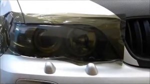 Тонировка передних фар черной пленкой у BMW