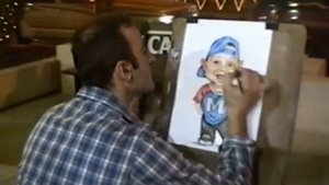 Художник шаржист рисует шаржи на фестивале в Дубае