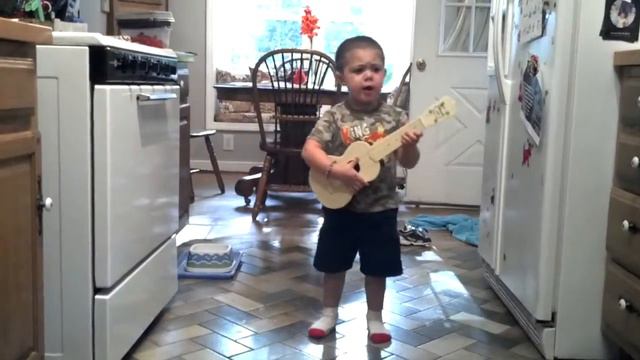 Boy singing "Bob the Builder" with ukulele. He's really belting it out. смотреть онлайн