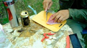 Alone camping and cooking food in forest