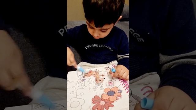 A cute kid painting with water