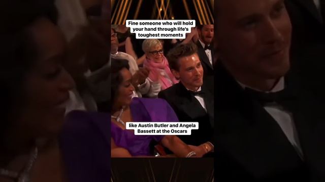 Angela Bassett and Austin Butler holding hands at the Oscars