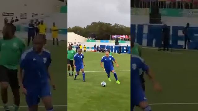 President Paul Kagame of Rwanda plays football with JJ Okocha, Fifa Chief