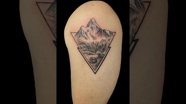 Skull Mountain and lion tattoos