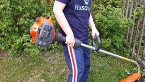 The first mowing of the grass with a Husqvarna 122C trimmer