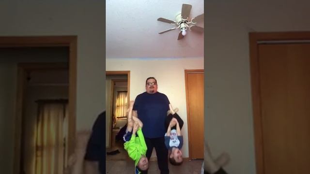 Man at Home Does Arm Workout Using Kids as Dumbbells - 1110238