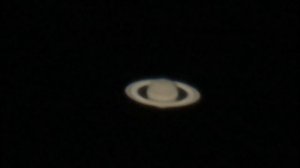 Planet Saturn through a Telescope