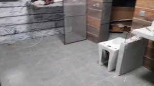 Отделка стены за печкой природным камнем.