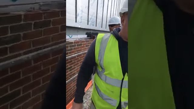 apprentice bricklayer laying his first brick