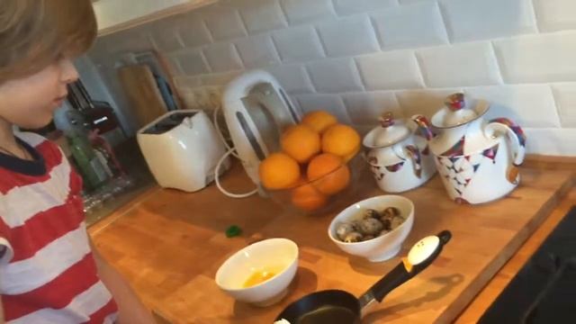 Слава жарит яичницу из перепелиных яиц и делает сок из апельсинов.