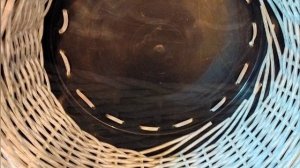Плетеное из ротанга низкое кашпо или лежак для домашних животных.