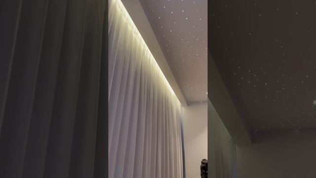 Star ceiling with white satin stretch ceiling membrane and fiber optic stars