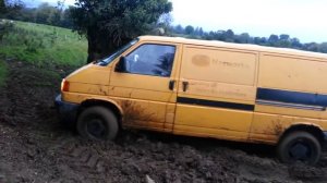 VW Transporter Syncro offroading in a field.