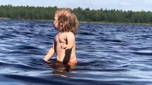 Little Sasha and a large lake Fun games in the water The little girl is bathing The baby is playing